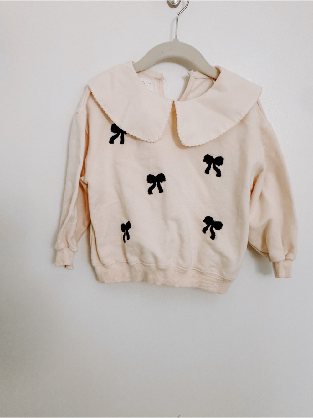 Zara Cream Sweatshirt with Black Bow Appliqués and lace trimmed collar.